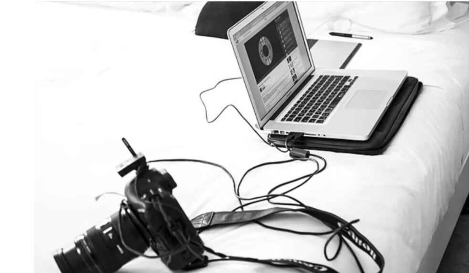 Laptop connected with a professional camera showing film editing setup for OTT film submission requirements.