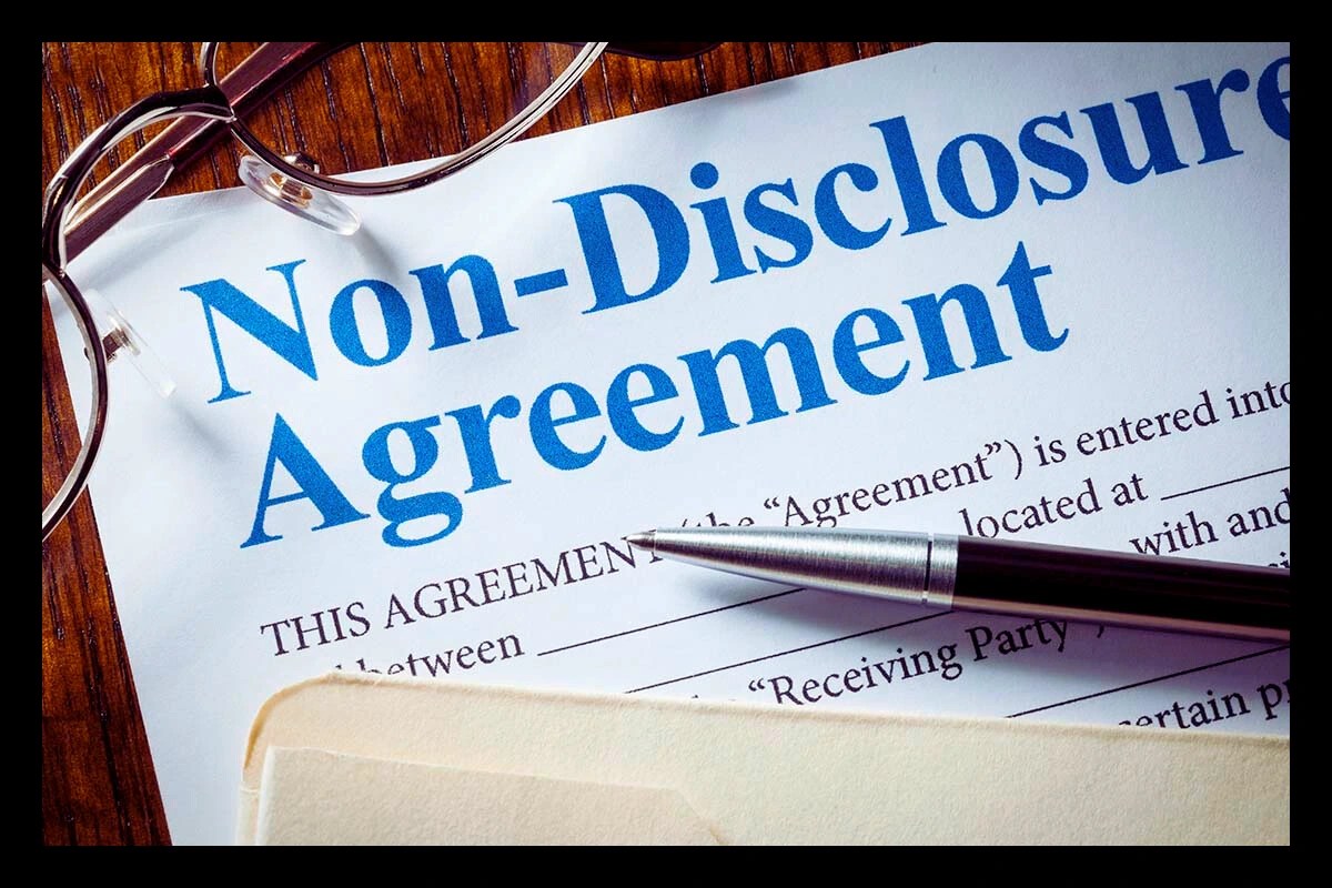 Close-up of a printed Non-Disclosure Agreement with a pen and glasses, representing essential legal security for cast and crew during pre-production.