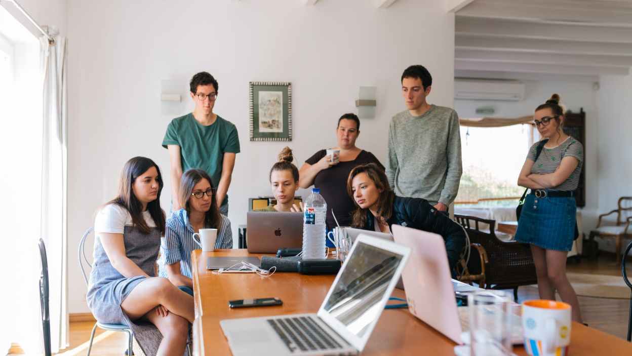 group of people watching on laptop