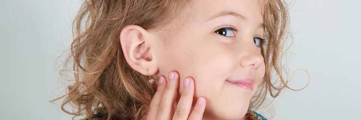 A girl child showing her earring