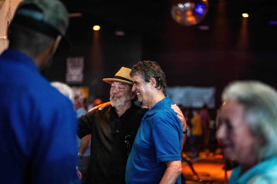 Richard Winham meets with guests at the retirement benefit concert at Barrelhouse Ballroom. Photo by Ray Soldano.