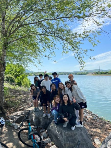 a group of international students in front of the river