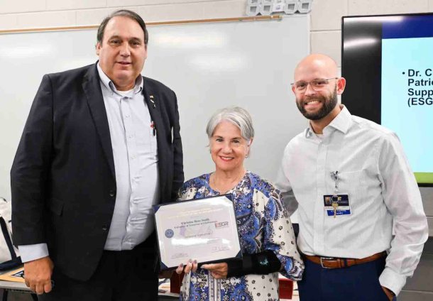 Retired Army Lt. Col. Scott Hardin, the ESGR Chattanooga committee chair, left, presents Dr. Chris Smith with the Patriot Award on Tuesday, Aug. 12. Smith was nominated for the award by Terry Ellis, right, a member of the School of Nursing faculty and a first lieutenant in the Army National Guard.