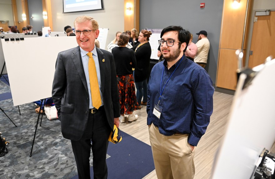 Chancellor Steve Angle and senior Juan Pena.