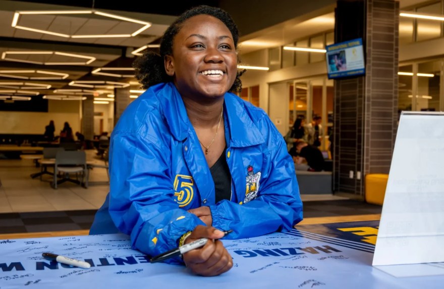 Chello Gardner signs a National Hazing Prevention Week banner during a “Mocs Don’t Haze” tabling event in 2023. Photo by Mason Edwards.