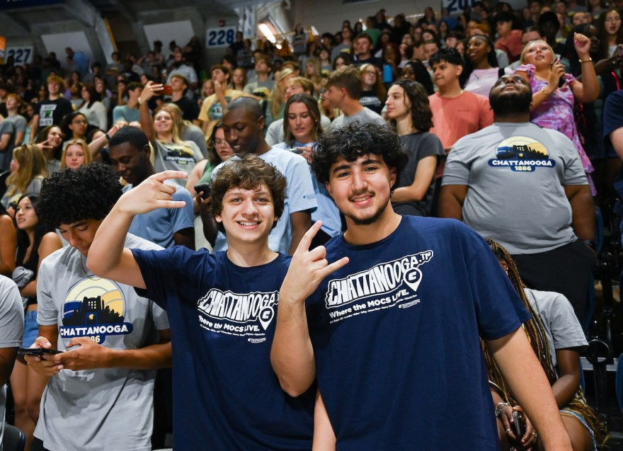 Students at the 2024 Convocation held up a "Power C." This year, "A Moc's First Class will immediately follow Convocation. Photo by Angela Foster.