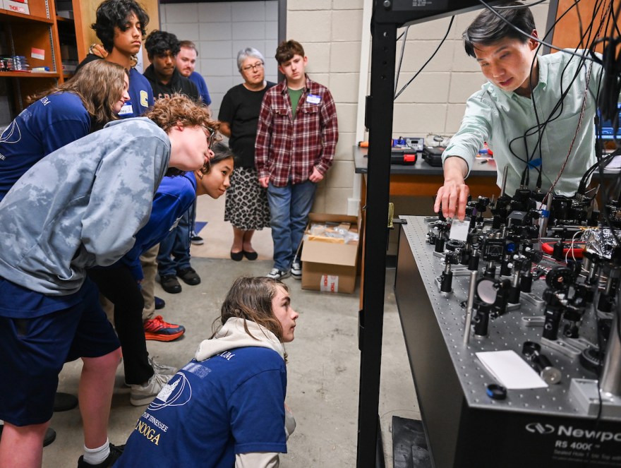 Dr. Tian Li leads a Quantum Camp demonstration in Grote Hall. Photo by Angela Foster.