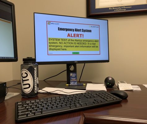 Laptop with "UTC-Alert" in the top left corner and large centered text "Emergency Alert System. Alert!" Centered below in medium text reads"SYSTEM TEST of the Alertus emergency alert system. NO ACTION IS NEEDED. IN a real emergency important alert information will be displayed here."