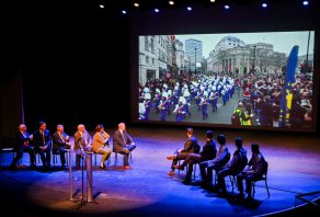 London Parade Invitation-23 Representatives from the London Parade office and the city of London along with UTC representatives, watch footage of the London Parade Wednesday, March 22, 2023 in the Hayes Concert Hall before presenting the Marching Mocs with their official invitation to participate in the London New Year’s Day Parade.