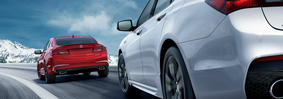 Red acura tlx with advance package in front of a white a-spec tlx