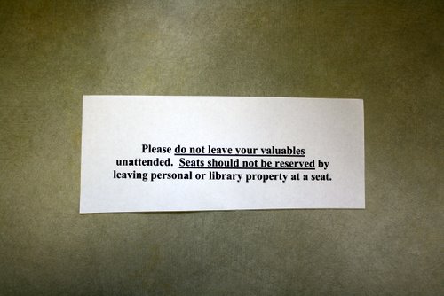 Library warning slip: Please do not leave your valuables unattended. Seats should not be reserved by leaving personal or library property at a seat.