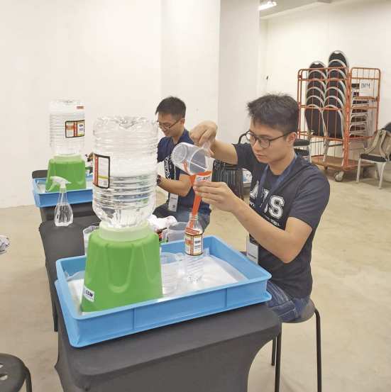 Filling up the bottles with hand sanitisers.