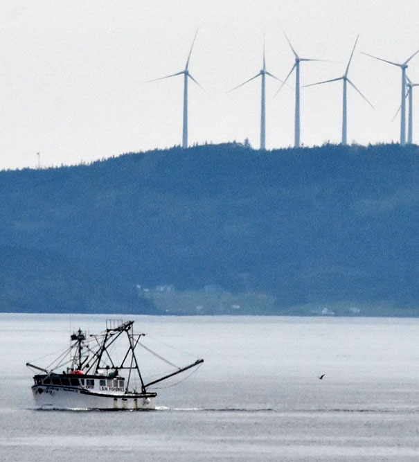 vessel with wind power farm in background