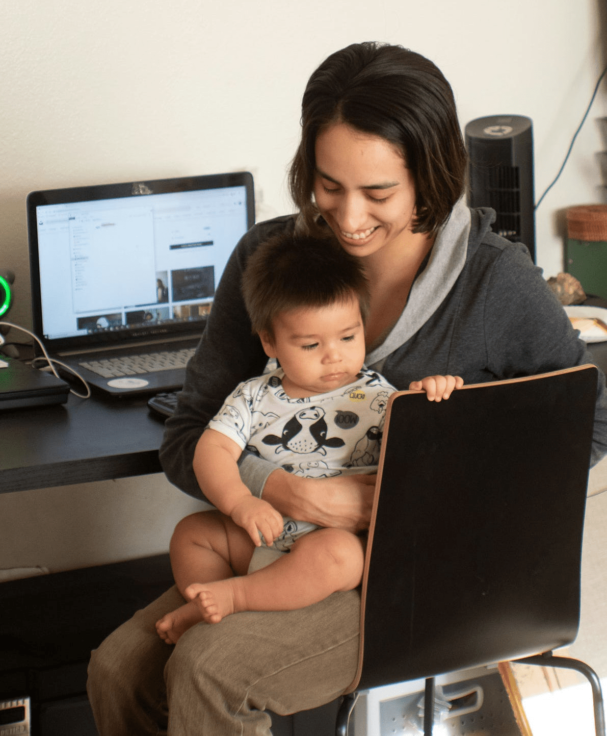 Working mother with child in her lap