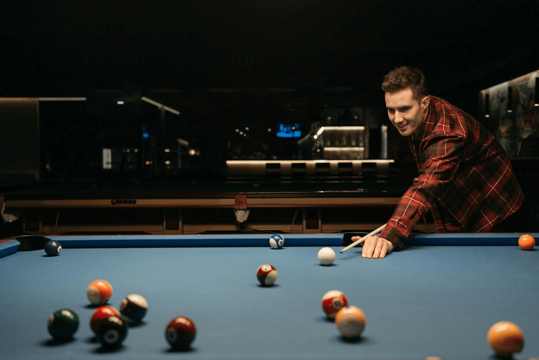 A person pointing to a target on a board.