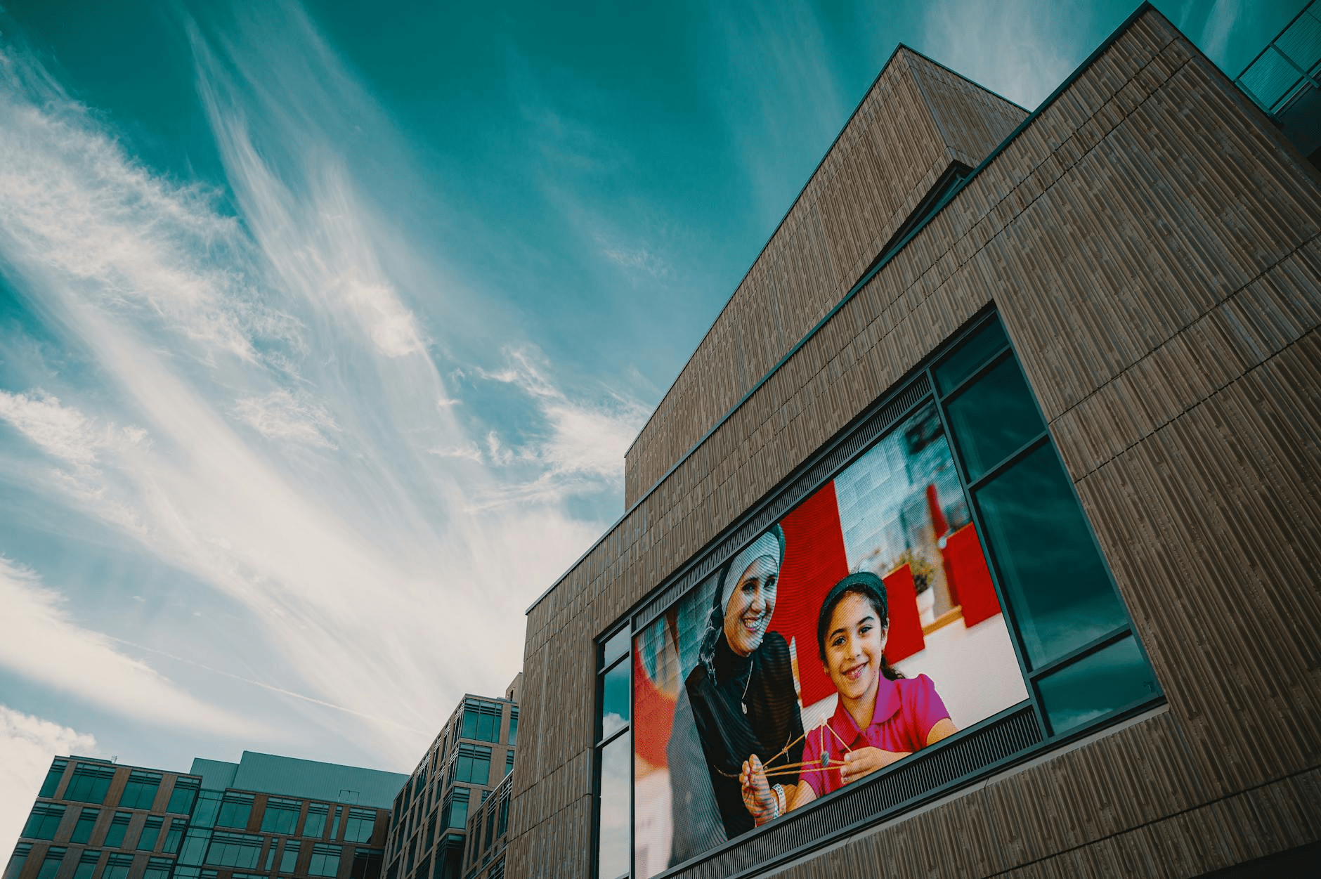 A person pointing at charts on a computer screen, representing a display advertising agency at work.