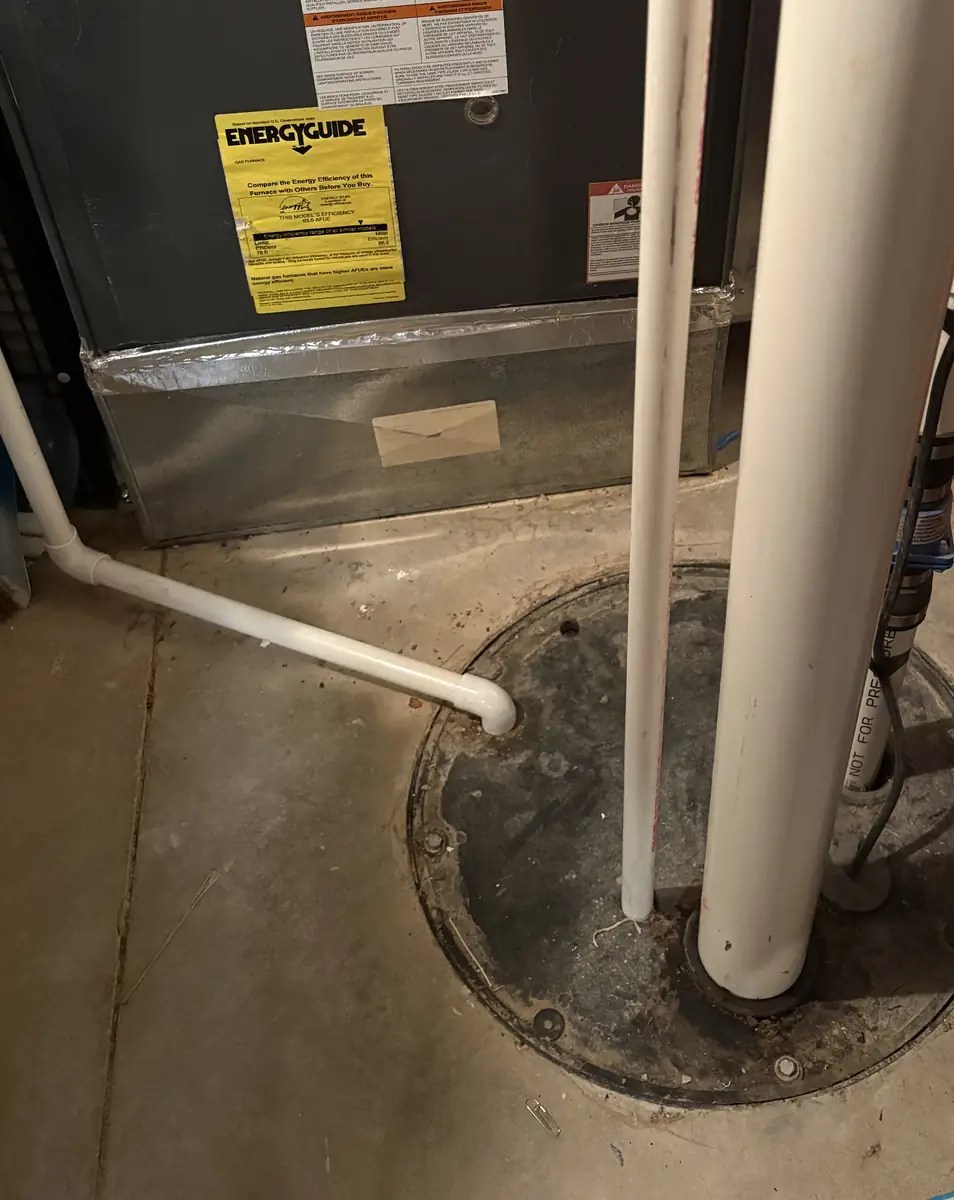 Sealed sump pit with twin discharge lines in a York County, PA basement, installed by Blue Tide Plumbing