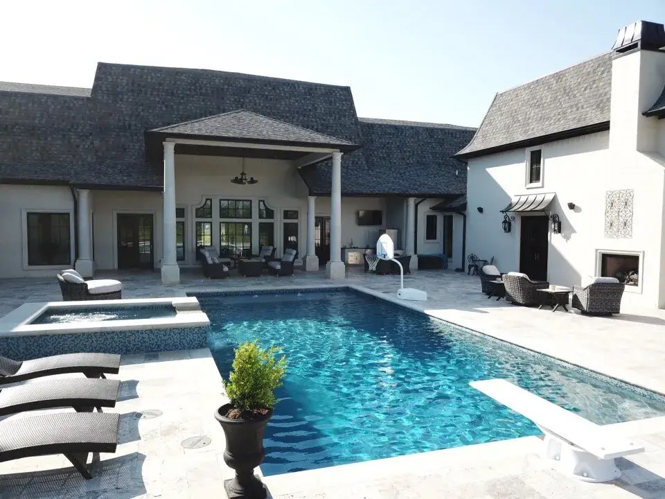 Luxury geometric swimming pool with spa and outdoor living area designed by Blue Water Pools LLC in Crowley, Texas