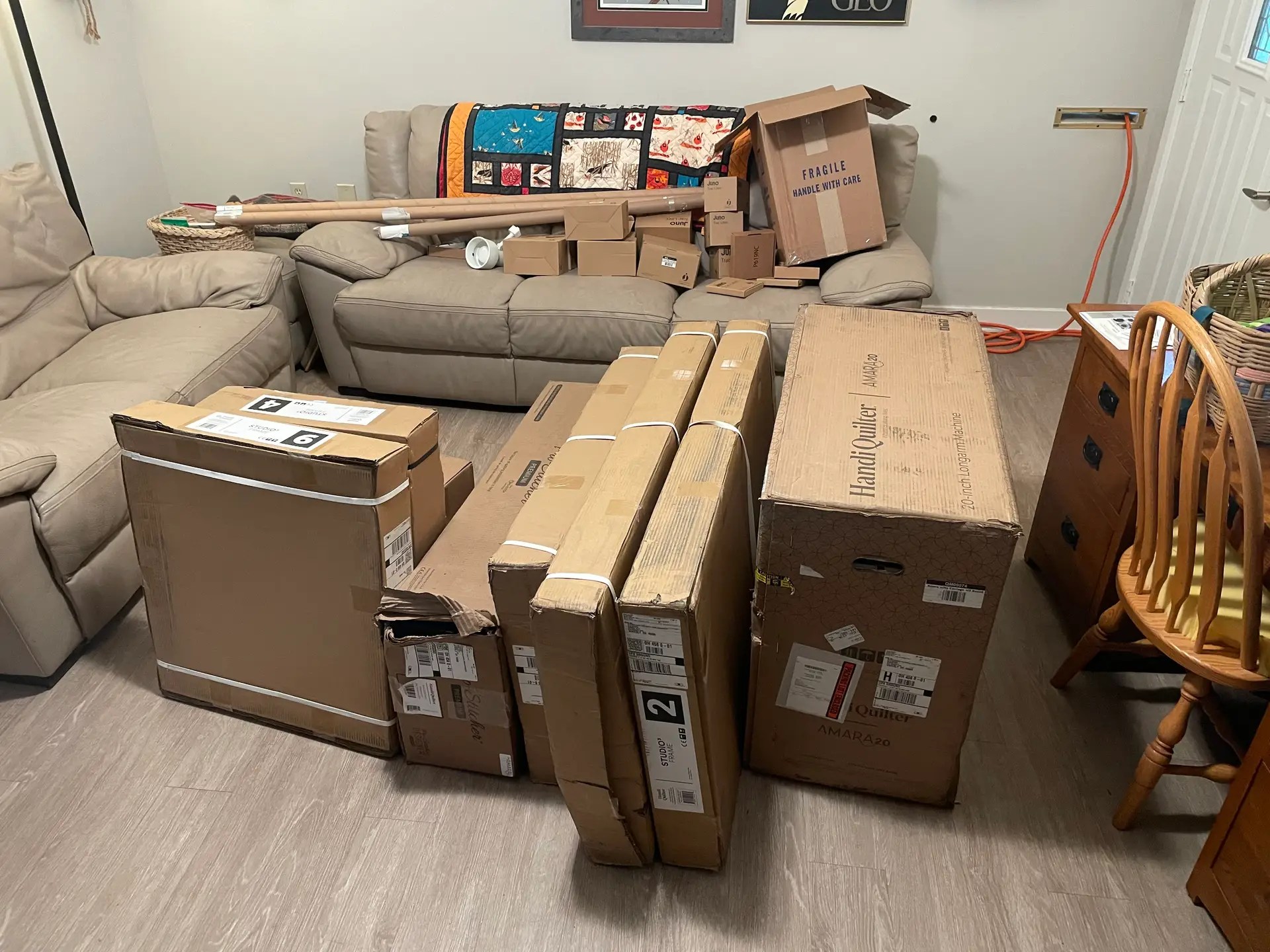 Nine large boxes with the longarm and smaller boxes on the couch fill my livingroom.