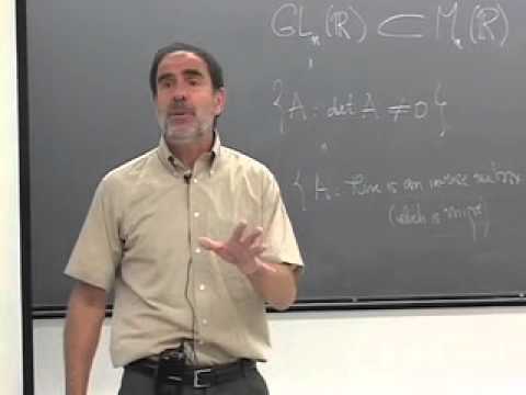 Benedict Gross standing in front of chalkboard with equations from Abstract Algebra Class