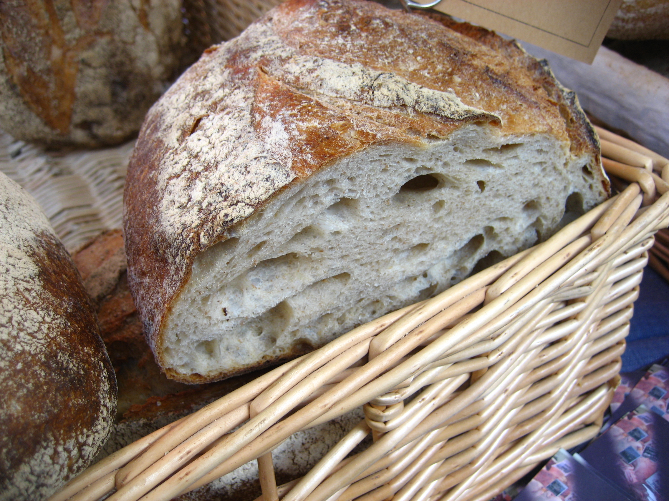 Loaf of bread with slice missing in a wicker basket