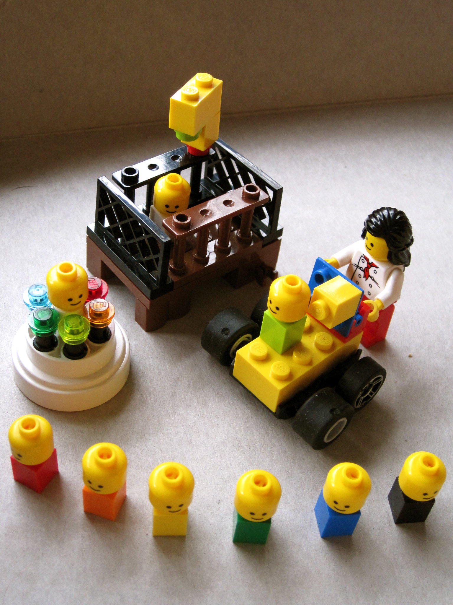 a LEGO scene with crib with mobile, Mom with stroller, an exersaucer, and 9 infants.