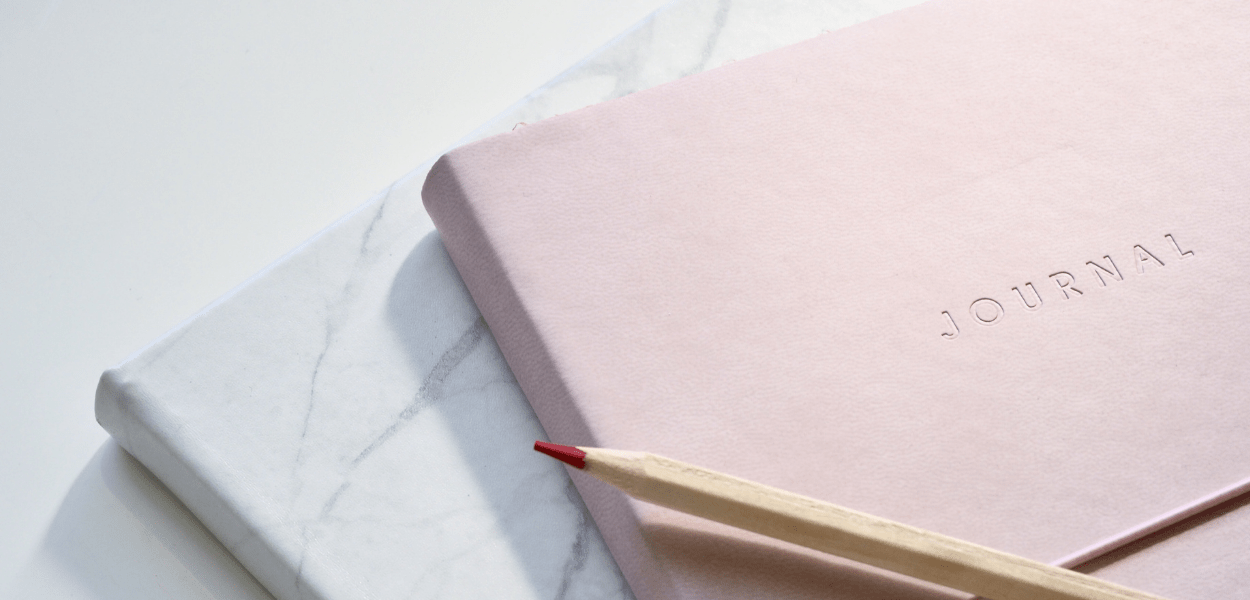 pink journal and colored pencil
