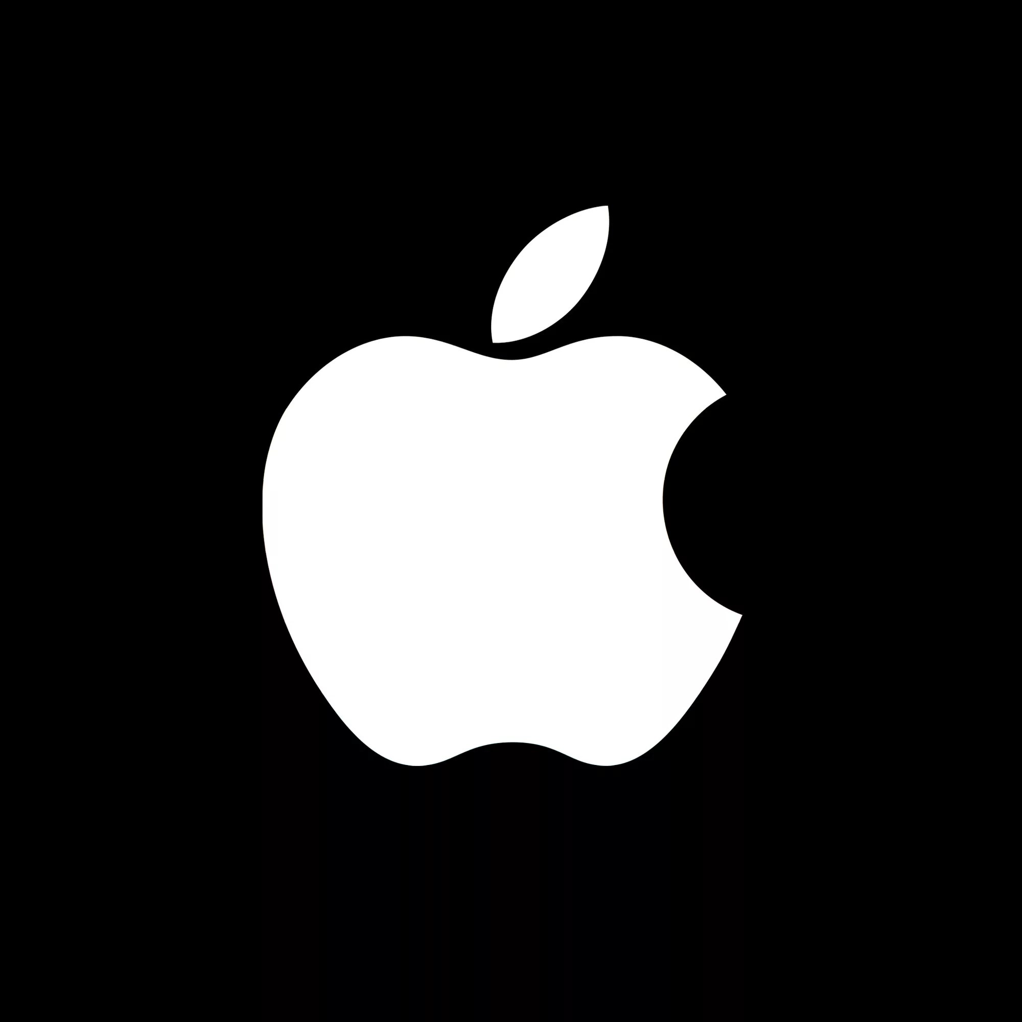 A white Apple with a bite taken out of the right side and a leaf on top, centered on a black background, evokes innovation—perfect for brands focused on technology or onshoring, like a Houston AI server plant.