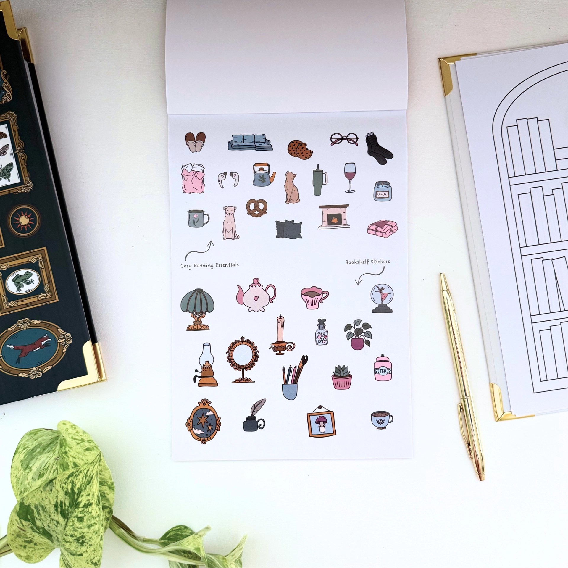 Open sticker sheet with cozy reading essentials and bookshelf stickers, including a kettle, cat, candle, fireplace, and mini teapots.