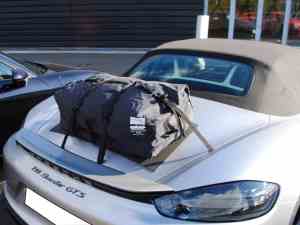 silver boxster outside a porsche garage with a boot-bag luggage rack fitted to the trunk