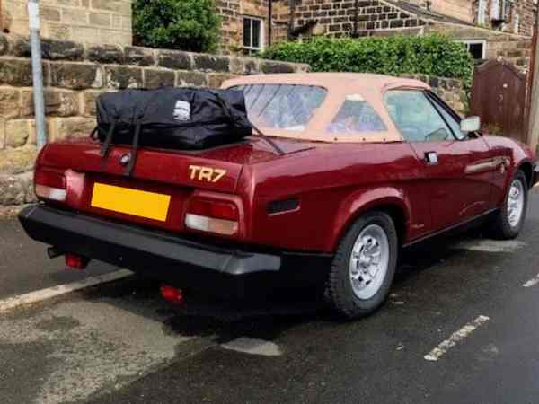 burgundy triumph tr7 with a biege hood and boot-bag original luggage rack fitted