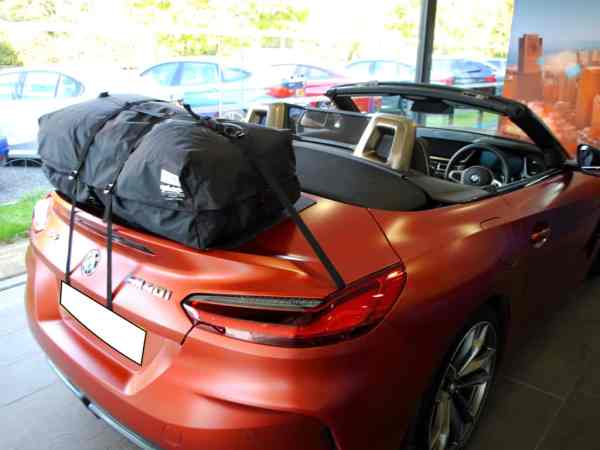 bronze matt bmw z4 g29 in a bmw showroom hood down with a boot-bag vacation luggage rack fitted