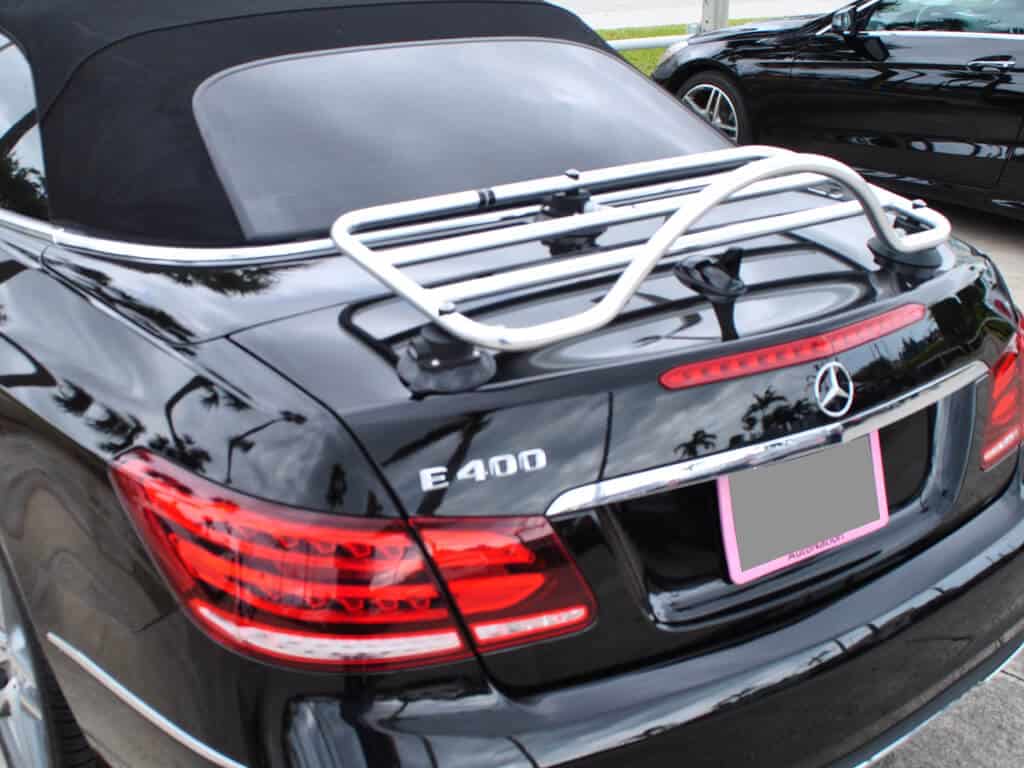 black mercedes e class cabrio with a luggage rack fitted