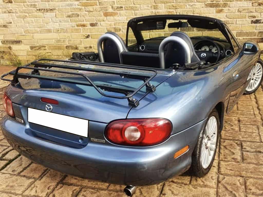 mazda mx5 mk2 with black luggage rack fitted parked outside house