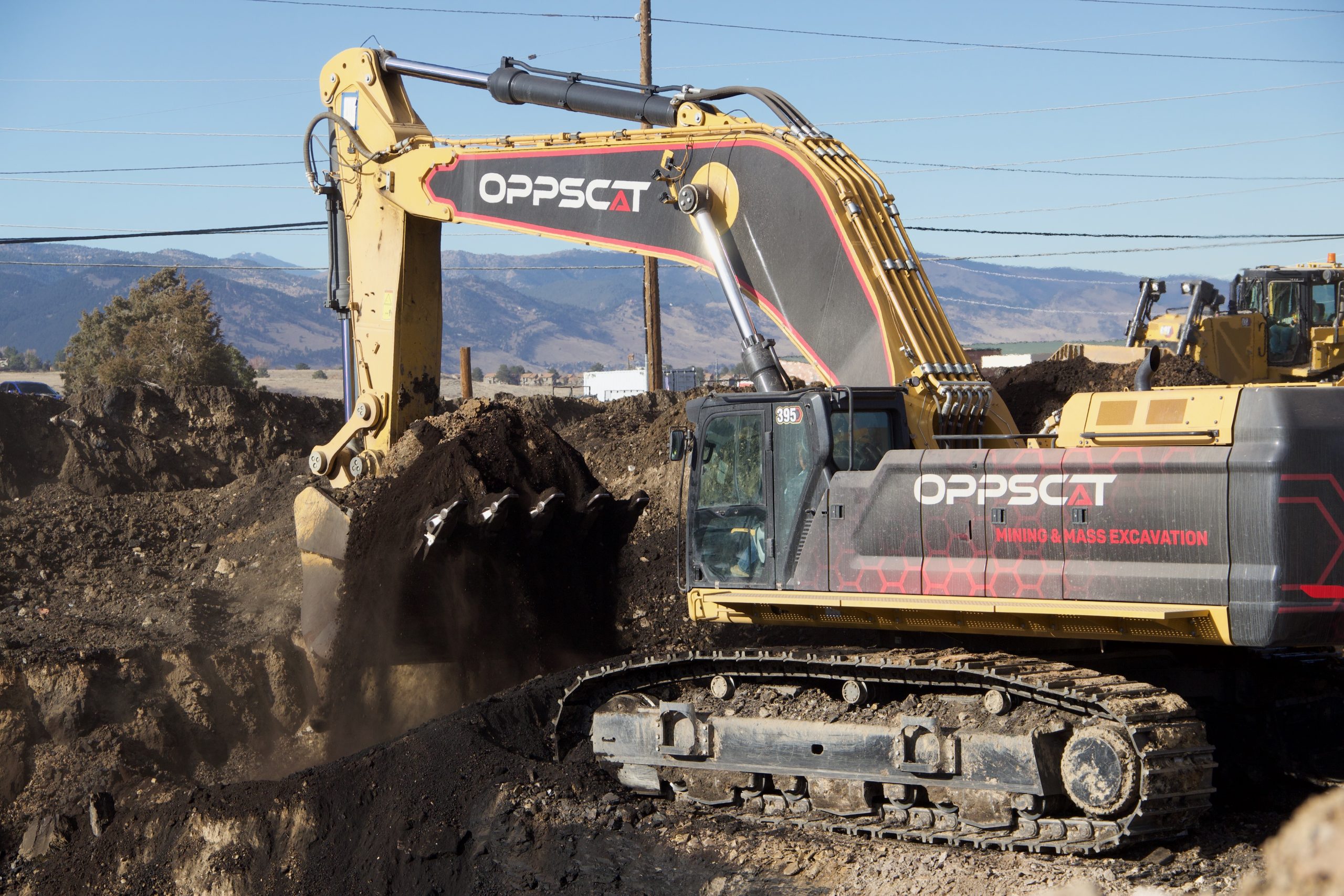 An excavator digs up coal from beneath the Marshall Mesa Trailhead.