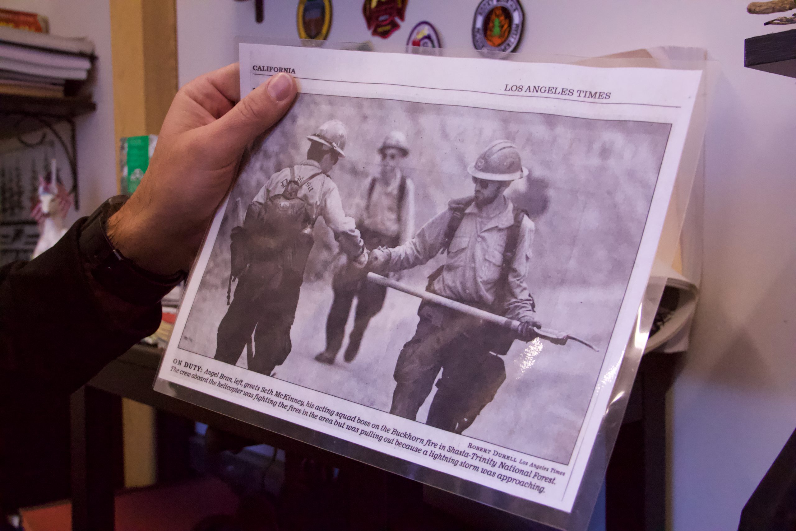 Seth McKinney, fire management officer for the Boulder County Sheriff's Office, holds a clipping from his time with the California Hotshot crews.