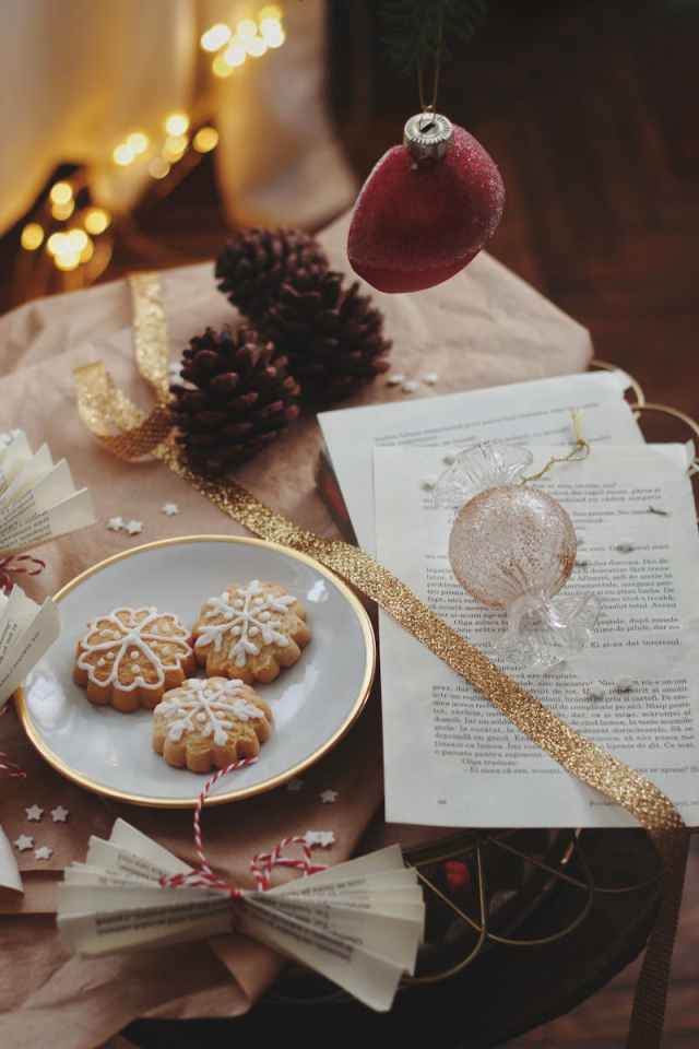 Cozy scene with Christmas cookies, ornaments, and warm festive decorations.