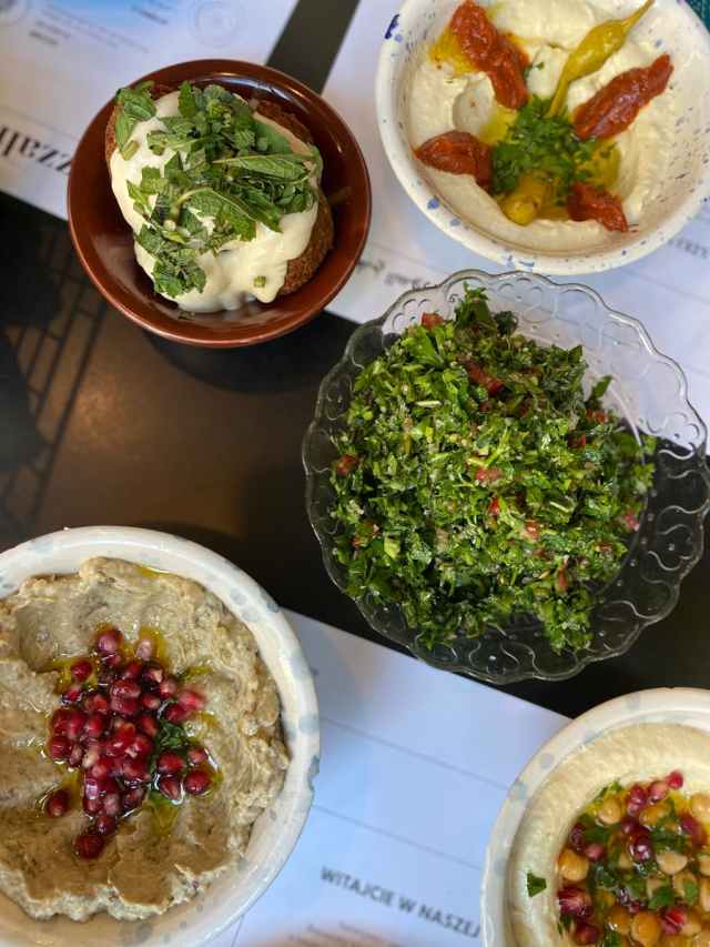 Top view of a vibrant Middle Eastern mezze spread with fresh ingredients.