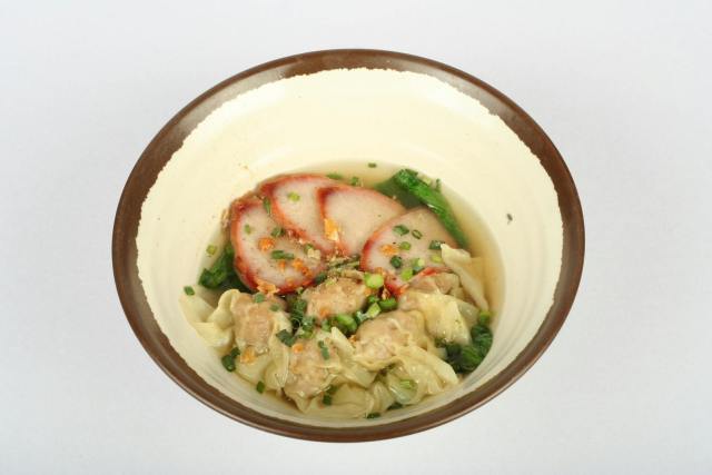 A savory bowl of wonton soup accompanied by sliced pork and fresh greens, perfect for Asian cuisine lovers.