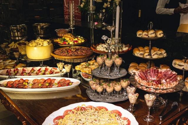 A lavish buffet spread featuring assorted appetizers and desserts in a restaurant setting.