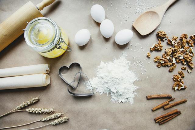 A collection of baking essentials including flour, eggs, and nuts, perfect for homemade recipes.