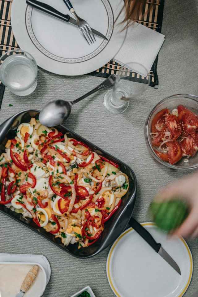 A vibrant vegetable casserole with peppers and cheese served on a dining table. Ready to eat meal.