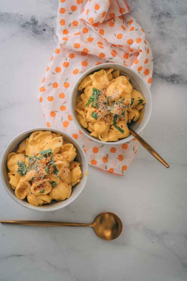 Delicious vegan mac and cheese plated beautifully with elegant presentation.