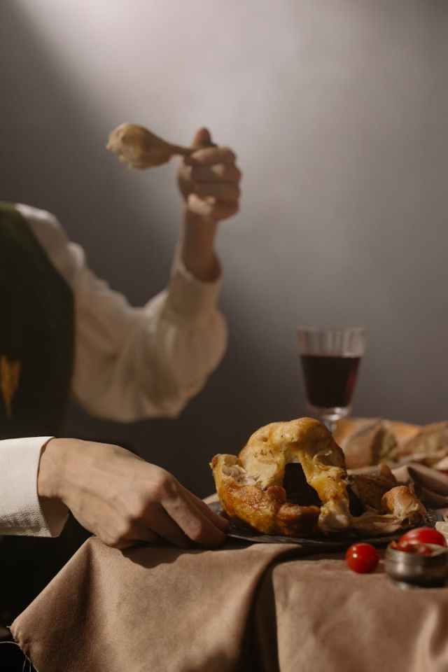 A sophisticated dining scene with roast chicken and wine, evoking a warm ambiance.