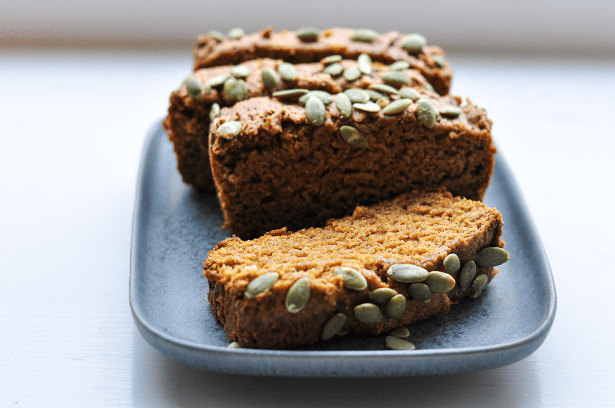 Loaf of gluten free pumpkin bread on a blue plate