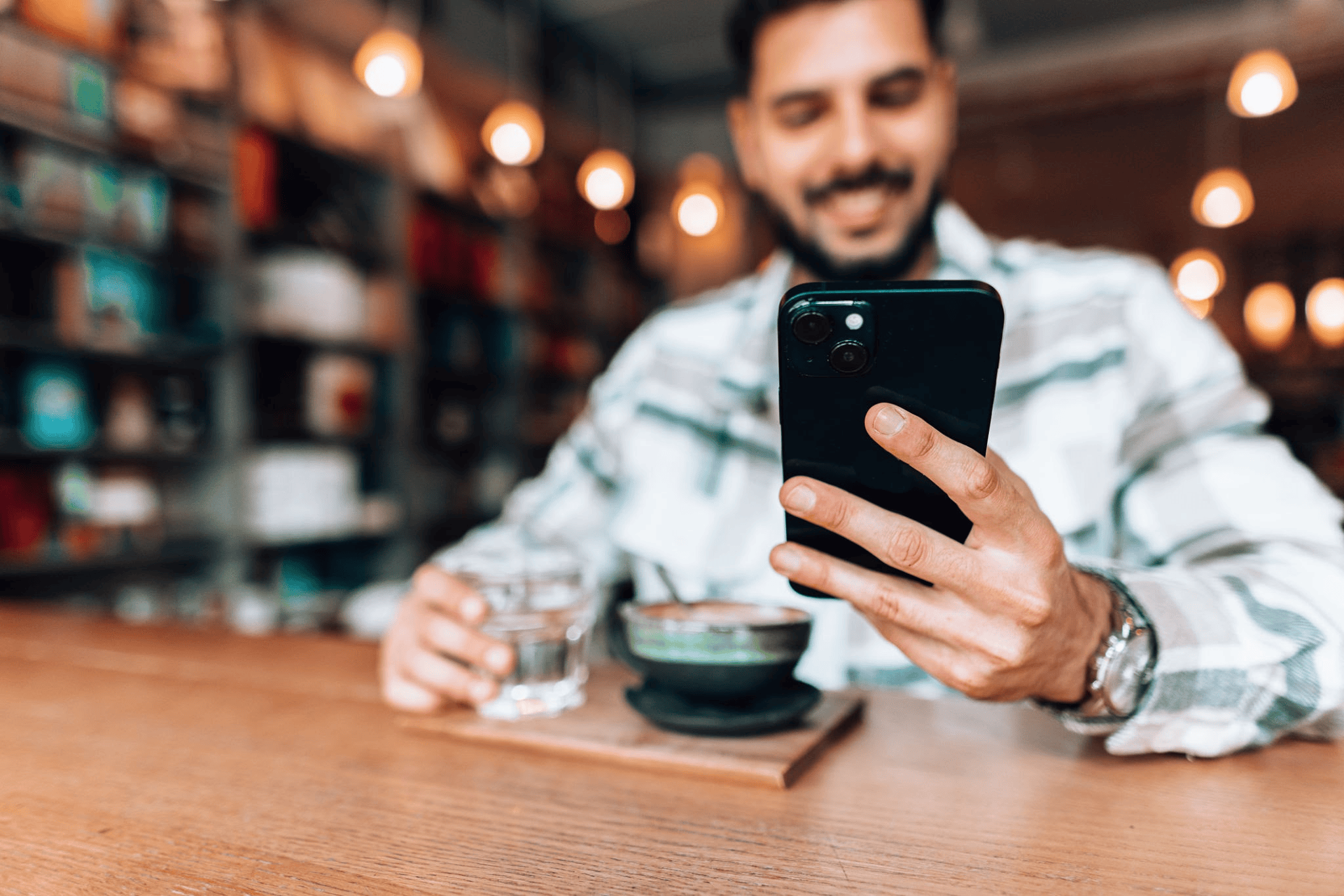 Customer sitting at a table using Instagram Reels for cafes strategy
