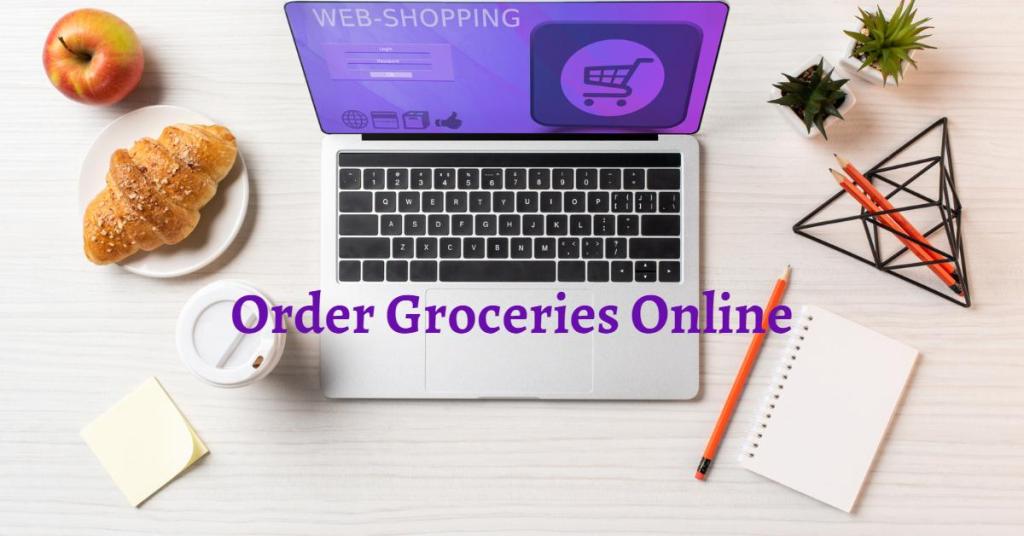 Order groceries online. Laptop, coffee, crossaint, apple, pencils on desk.