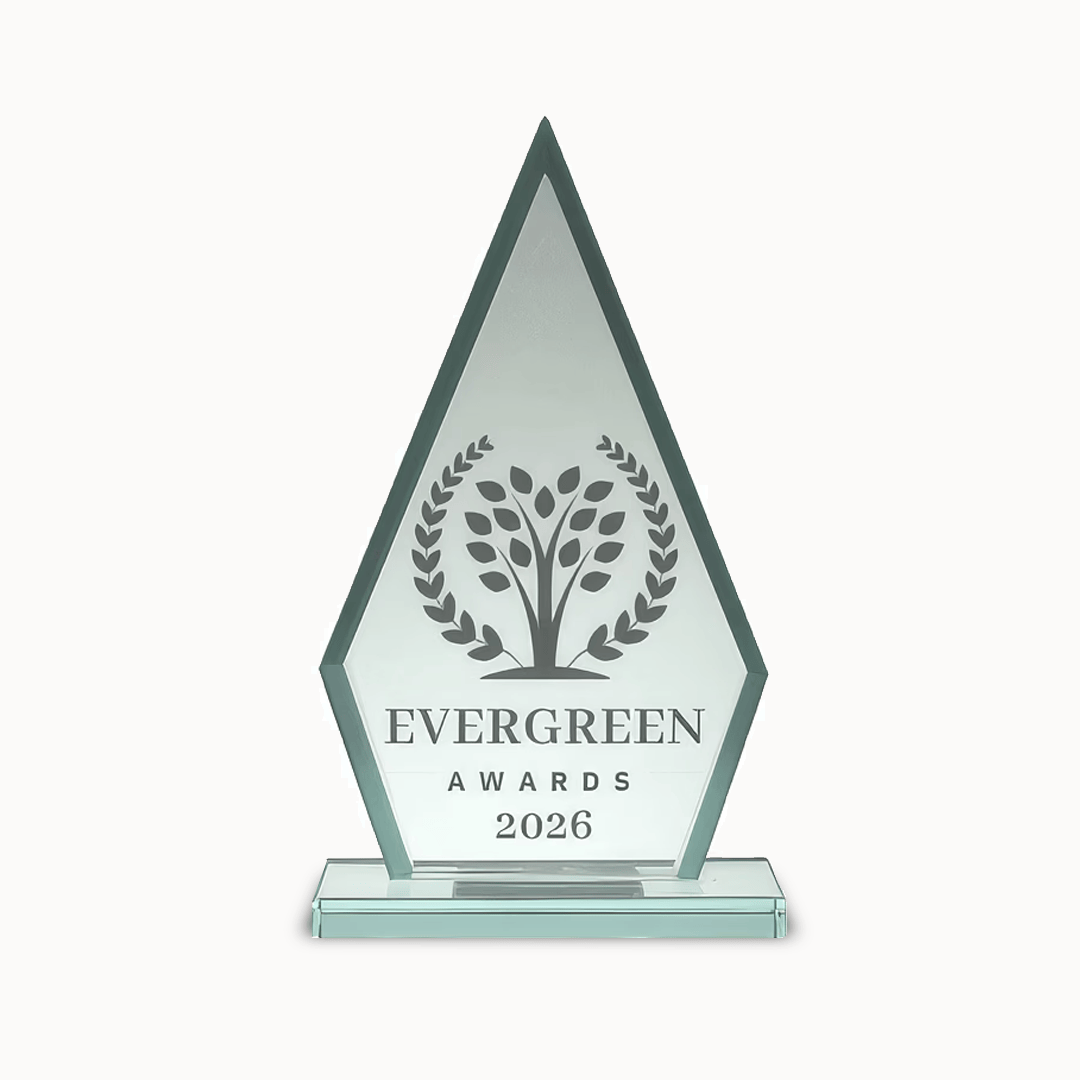 Crystal trophy with laurel wreath and tree, engraved "EVERGREEN AWARDS 2026" on front.