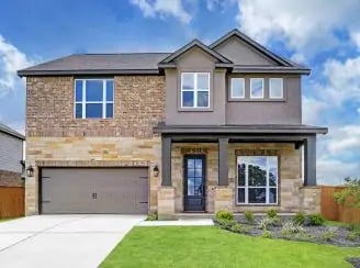 Front view of a modern two-story house with a brick facade and a landscaped front yard.