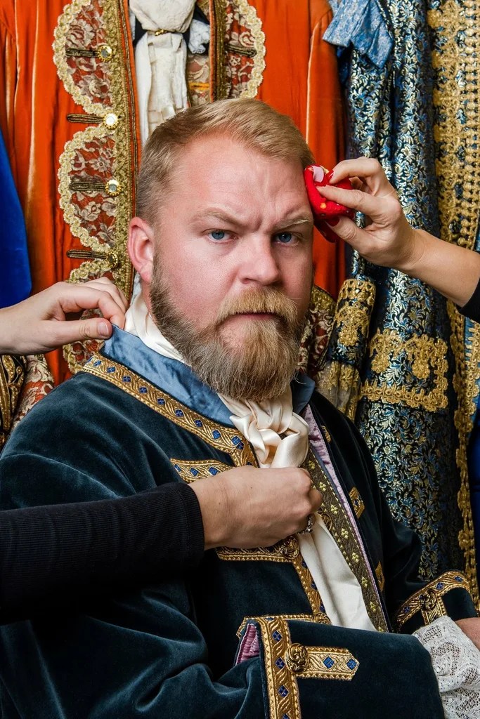 Brenden dressing in Tudor outfit, stage photo